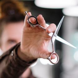 Hand holding sharp scissors